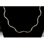 A 9ct gold fancy two tone necklace, with curved alternate links of yellow and white gold,  length