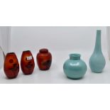 A collection of four Poole Pottery vases and one lidded jar Condition: No obvious signs of damage or