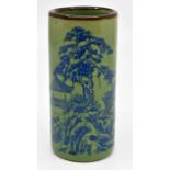 Small green ground ceramic Chinese brush pot with blue scenery decoration, signed underneath