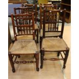 A set of six 19th Century Elm dining chairs, spindle back with rushed seats, raised on turned