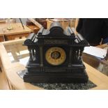 A Victorian slate mantle clock, architectural design with pillared columns and carved decoration,
