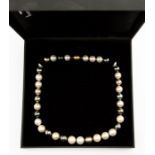 A Tahitian pearl necklace compromising black, cream, grey and white alternating pearls, each approx.