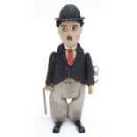 Schuco: A 1930's Clockwork Charlie Chaplin figure working mechanism, with key, not original,