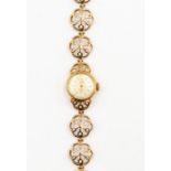 A Cyma ladies bracelet watch, round dial, champagne dial, baton markers, with integral round open