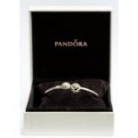 Pandora- A Pandora silver bangle bracelet with diamond set heart charm, the bangle inscribed 'I'