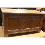 A 20th Century oak joined blanket chest, rectangular lid above moon shaped carving with three panels