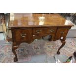 A George I revival walnut lowboy, rectangular top fitted with three single frieze drawers with brass