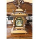 An early 20th Century German walnut cased eight day bracket clock, the case with turned finials to