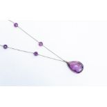 A vintage amethyst necklace, comprising white metal chain links with alternate amethyst faceted bead