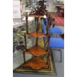 A mid Victorian walnut four tier graduated corner wot-not each tier raised on barley twist