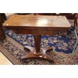 A Victorian mahogany fold over pedestal card table, the fold-over top raised on an octagonal column,