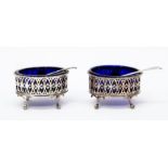 A pair of Sheffield 1776 salts with liners and spoons (one George III 1789 and one Birmingham 1931),
