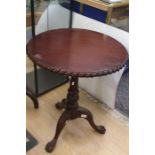 A Chippendale style mahogany circular pie crust occasional table on cabriole tripod legs with claw