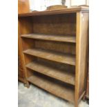 A 20th Century oak bookcase, carved back above four shelves on square supports.130cm H x 102cm W