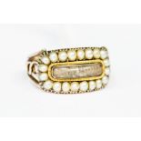 A Georgian mourning ring, comprising a central hair compartment within a border of half pearls,
