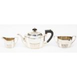 A Victorian silver tea service comprising a teapot, milk jug and sugar bowl, the teapot with
