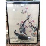 Two early 20th Century Chinese style embroidered panels both depicting birds, framed