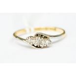 A three stone diamond and 18ct gold ring, illusion set graduated diamonds, size P, total gross