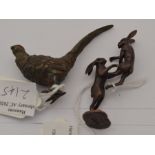A small modern bronze sculpture of boxing hares, initialled D.M, together with a cold pained