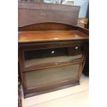An Edwardian beech Lebus two tier bookcase with glazed doors
