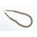 A silver bead necklace, comprising graduated pebble like beads, length approx. 19'', total gross
