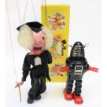 A 1960's Japanese tinplate robot, together with a boxed Pelham Puppet, Schoolteacher. (2)