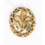 A Victorian mourning brooch, unmarked yellow metal assessed as 9ct gold, the hair set in the form of