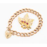A 9ct rose gold curb link padlock bracelet together with a 9ct pierced leaf brooch set with three