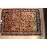 A 20th Century hand knotted silk prayer rug, with birds in branches and floral decoration on a