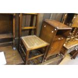 A 20th Century mahogany bedside cupboard; An oak cane seated chair (2)