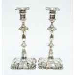 A pair of George V filled silver candlesticks, Sheffield 1903, stepped base with foliate design,