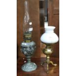 A pewter decorative oil lamp and also a brass early 20th Century oil lamp