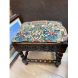 A 19th Century style oak carved footstool, on turned supports and stretchers.