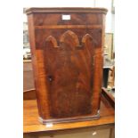 A small cross-banded mahogany single door corner cupboard, possibly converted from the waist of a