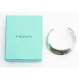 Tiffany & Co- A silver Tiffany & Co torque bangle, by Elsa Perretti, from the 'Swirl' range,