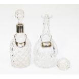 Two cut glass crystal decanters, one silver rimmed both with silver drink labels, one stopper A.F