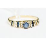 A sapphire and diamond 14ct gold ring, set with an oval sapphire to the centre with alternate