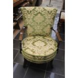 A Victorian mahogany upholstered chair, tapestry upholstery circular seat, raised on sabre feet.