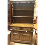 A 20th Century oak dresser, moulded cornice above egg trim finials with two shelves, rectangular
