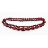 A graduated faceted cherry Bakelite type/composite bead necklace, largest bead approx. 25mm x