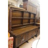 A 20th Century oak dresser on sideboard, moulded cornice above two tier shelves on a rectangular