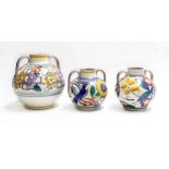 3 Poole pottery twin handled ovoid vases, decorated with traditional flower patterns, marked to