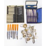 A collection of flat wares with cased butter knives with silver handles and silver christening