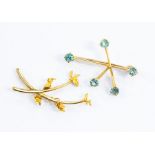 An aquamarine and unmarked yellow metal assessed as 18ct gold brooch in the form of rays with