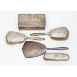 A George V Art Deco silver brush set, Birmingham 1930 and 1935, comprising three brushes and a