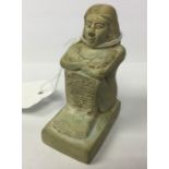 An Ancient Egyptian carved funerary figure of a Scribe in seated position. 70mm in height. Width