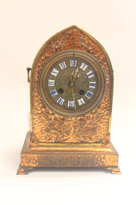 A mid 19th Century French mantel clock, encased in repousse copper work, entitled Carpe Diem