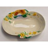 A Clarice Cliff Newport pottery oval dish, moulded and painted with flowers and a bridge over a