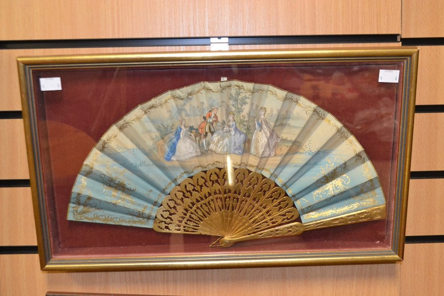 A Victorian hand painted fan, depicting an 18th Century courting couple, presented in a framed case,