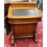 A mid Victorian walnut Davenport, a stationary box above an inlay writing slope, opens to pigeon